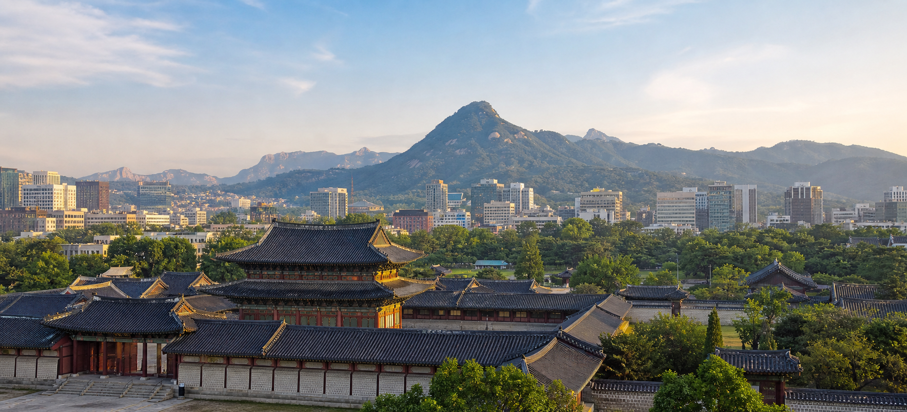 A wide editorial view of palace rooftops, central Seoul, and mountain ridges
